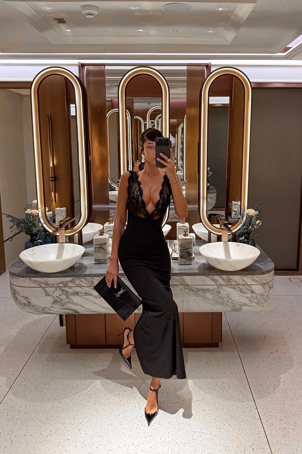 Black lace plunge neck maxi dress with sleek body-skimming fit, styled for formal event