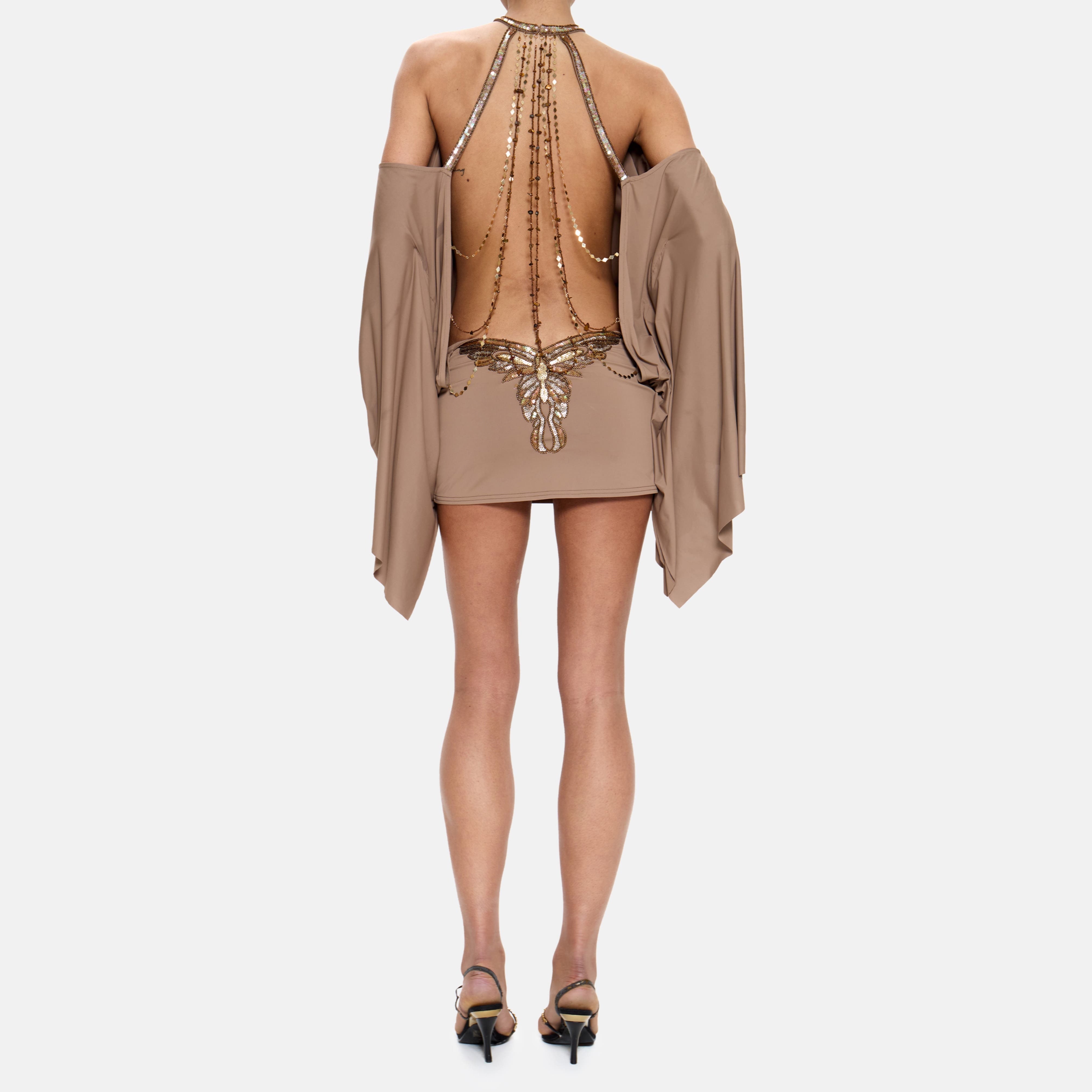 Beige dress with embellishments on a white background