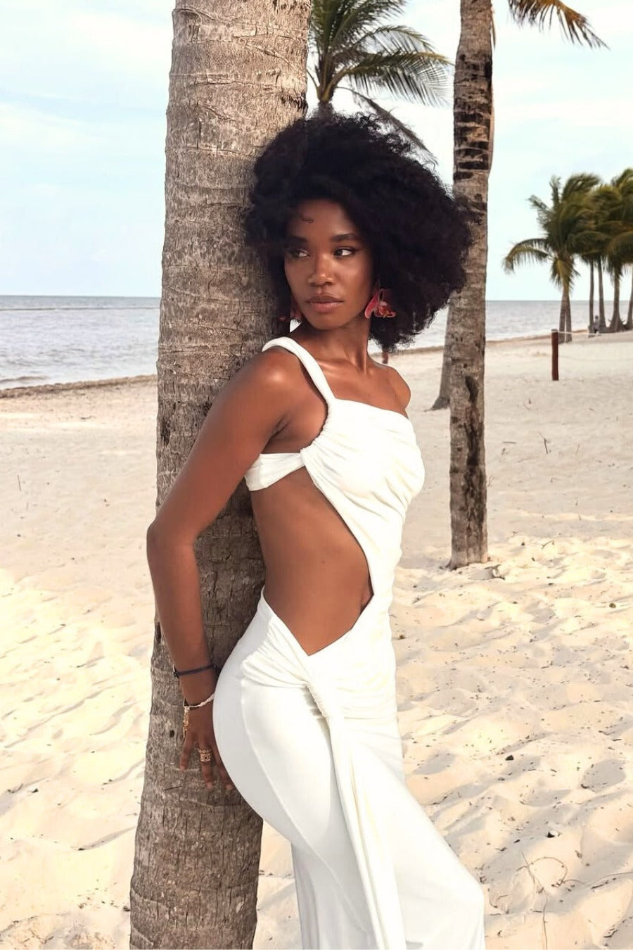 White asymmetric formal maxi dress with structured one-shoulder and waist cut-out