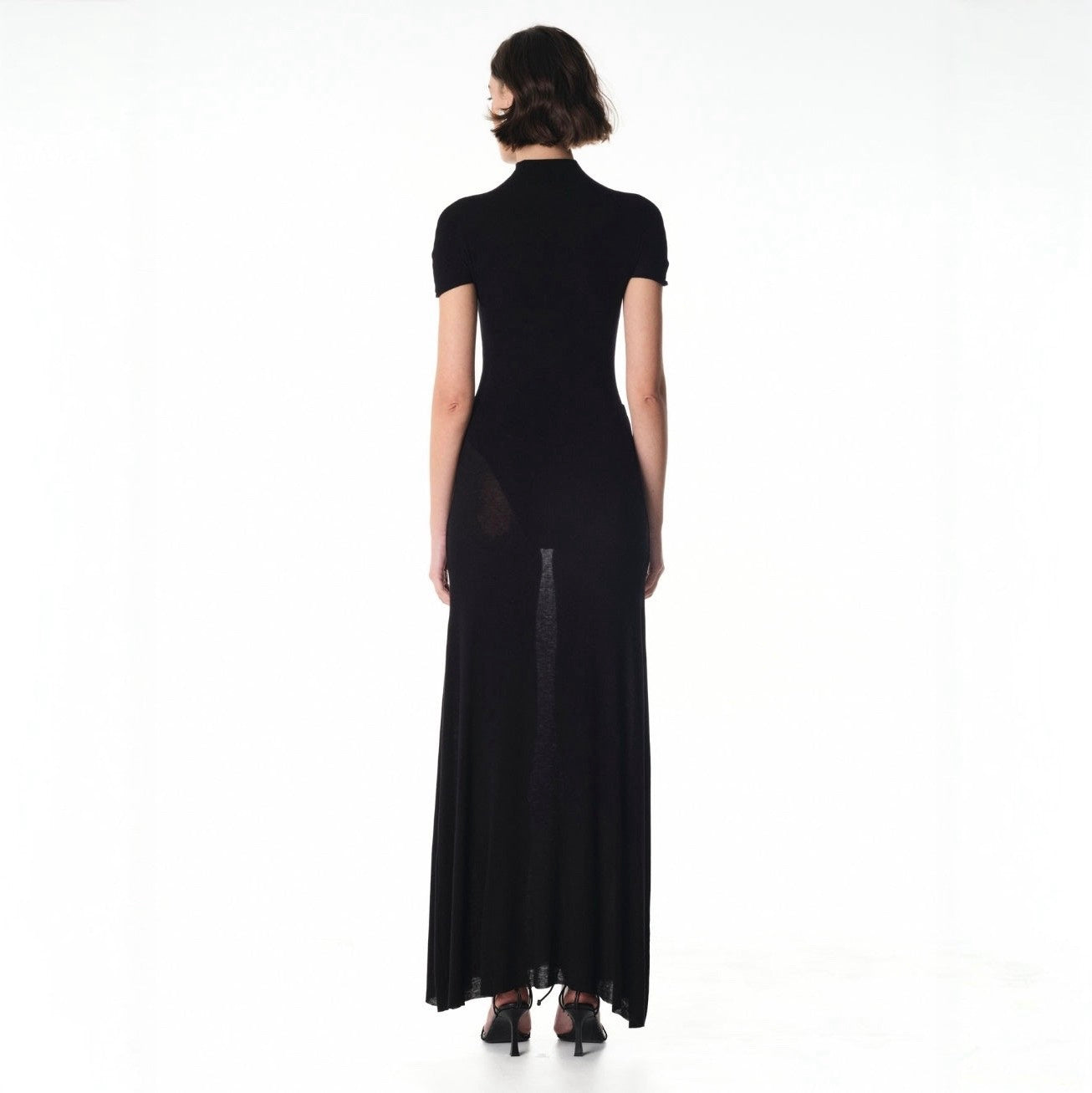 Black dress with sheer panels on a white background