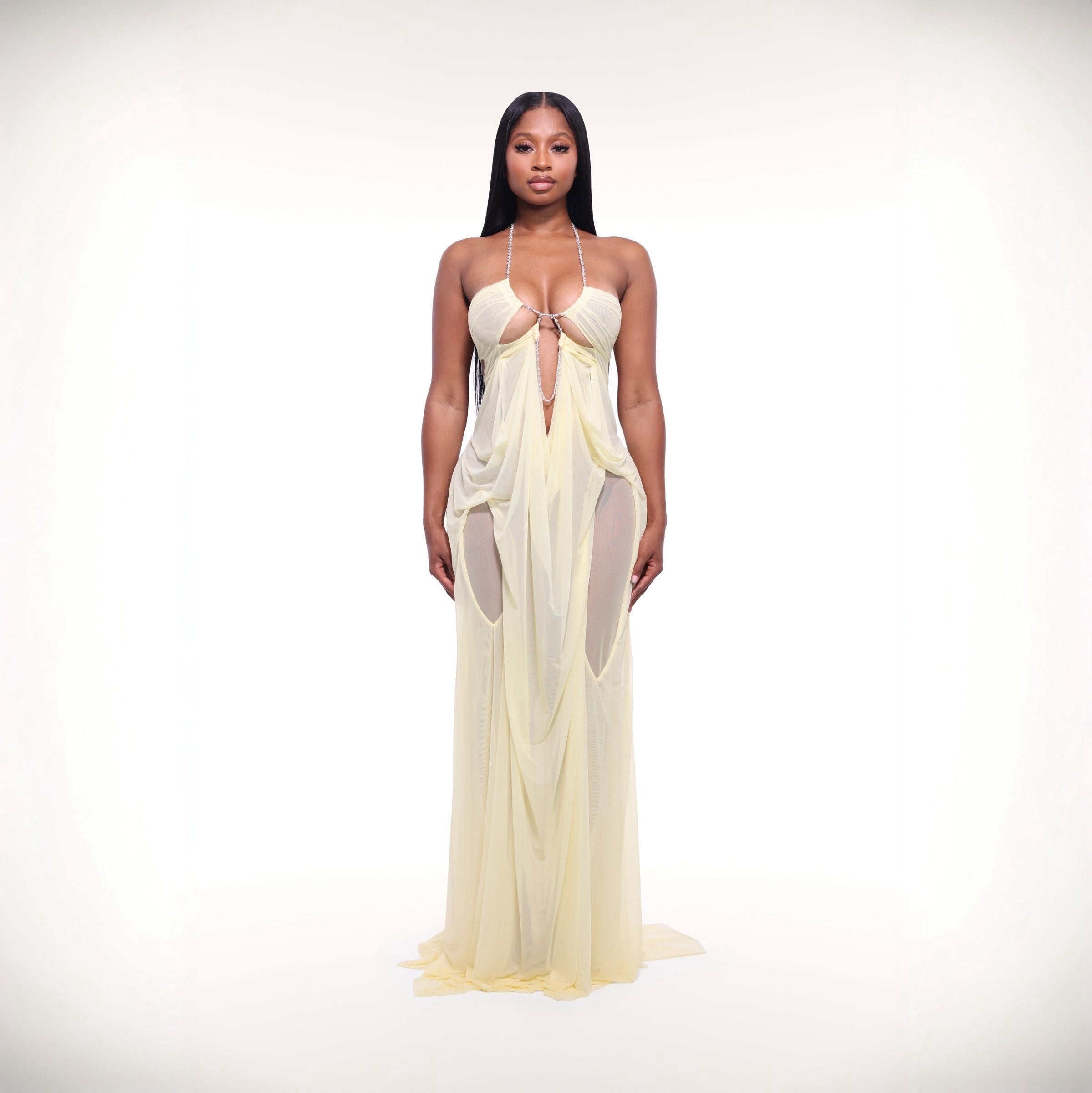 Woman wearing a sheer white dress on a white background