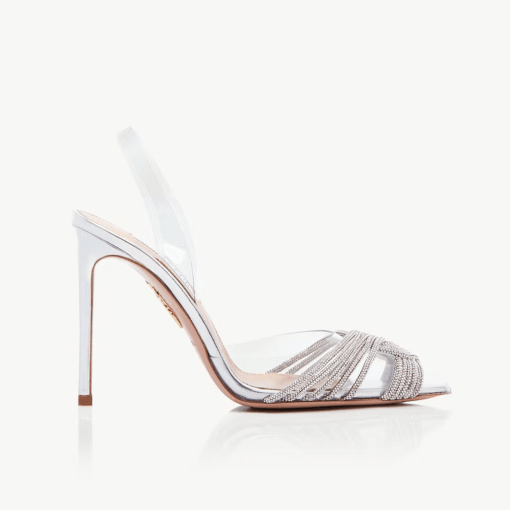 Silver high-heeled shoe with intricate design on a white background