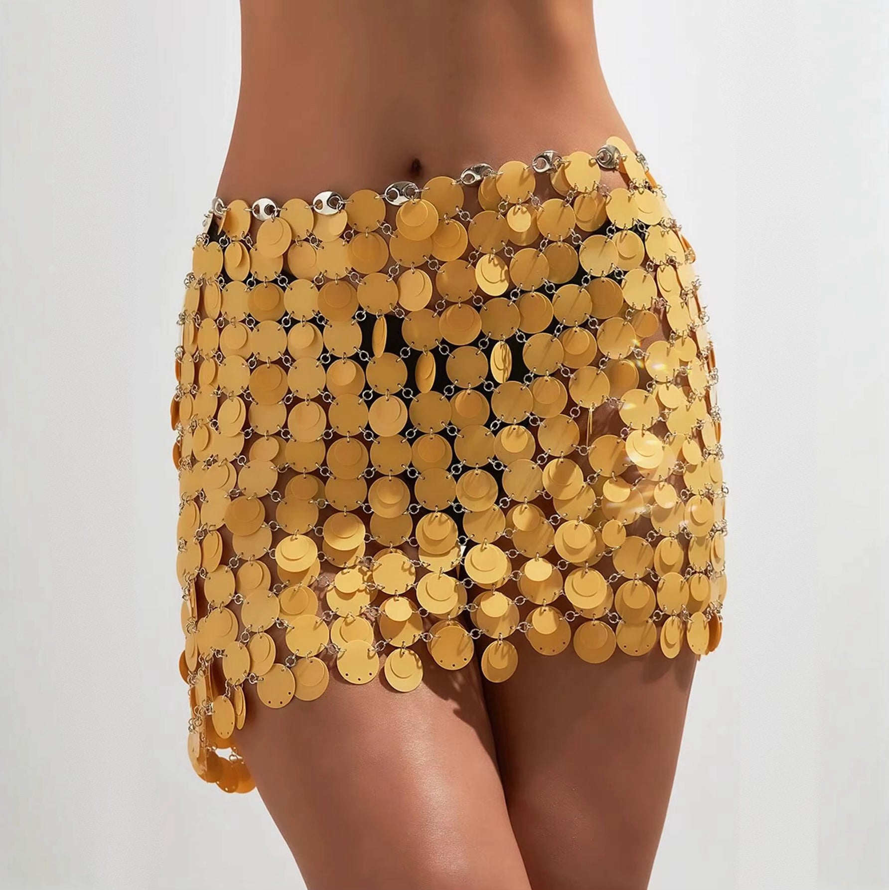 Yellow sequin skirt worn by a person on a plain background