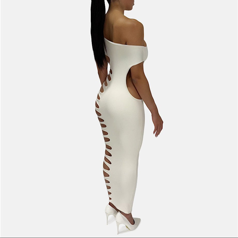 Woman wearing a white strapless dress with cut-out sides on a white background