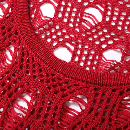 Close-up of red knitted fabric with a lace-like pattern