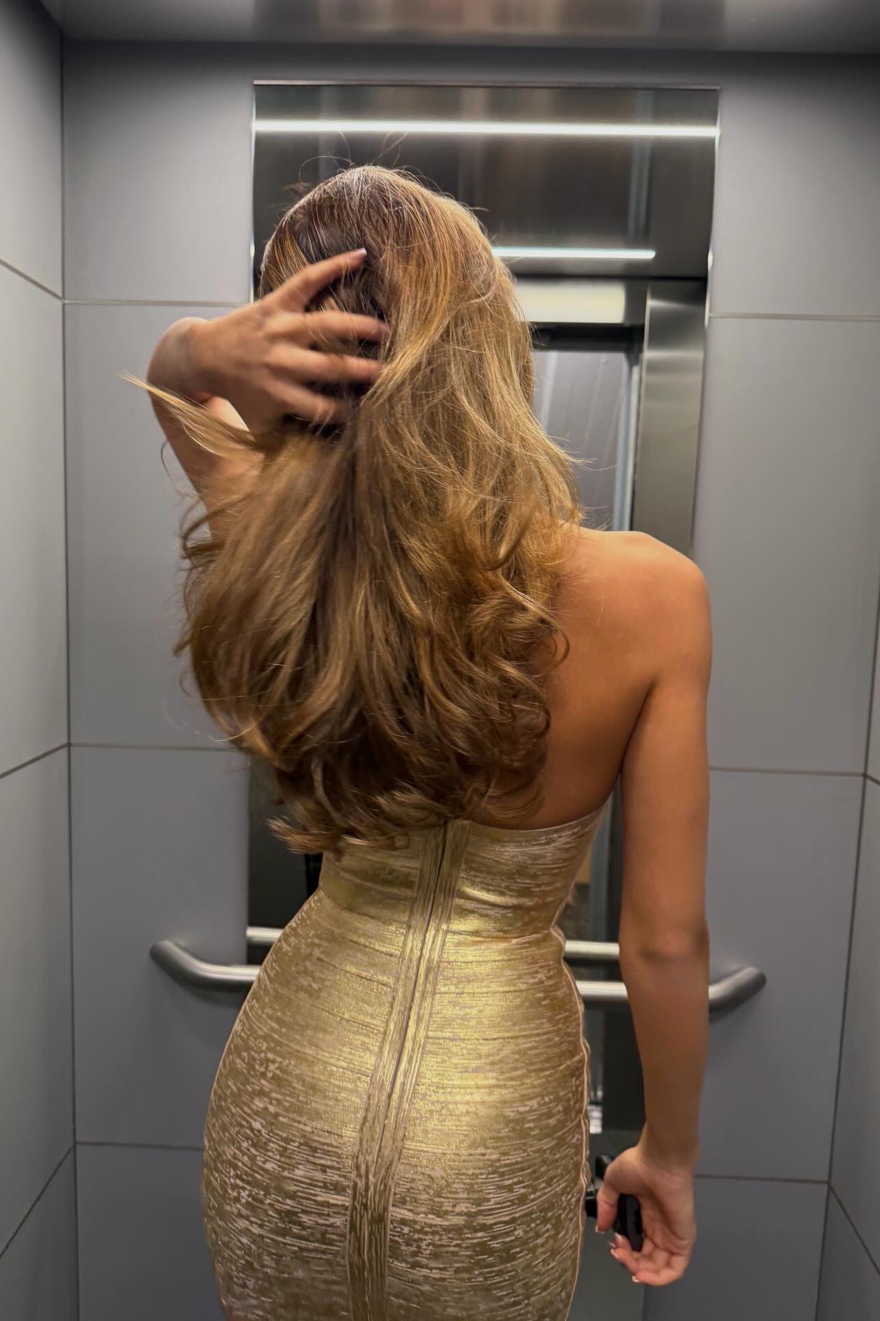 Gloss Muse gold metallic mini dress, close-up of halter strap and bandage texture