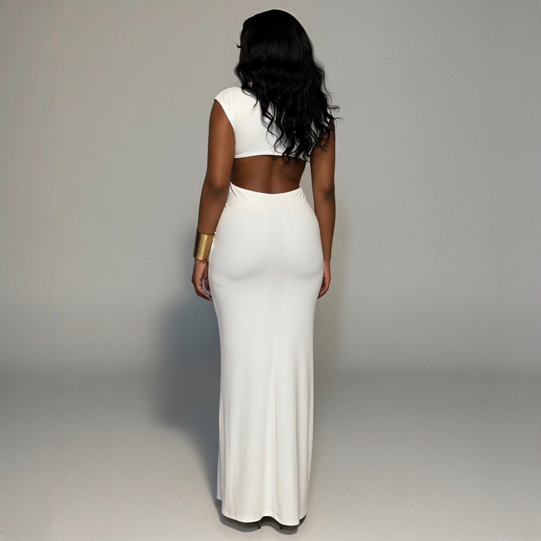 Woman wearing a white dress with a cutout design on a gray background