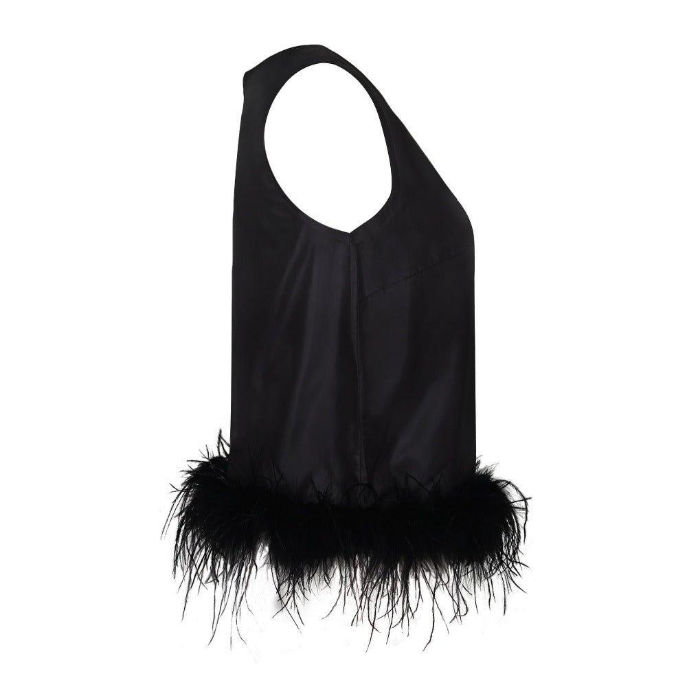Black sleeveless top with feather details on a white background