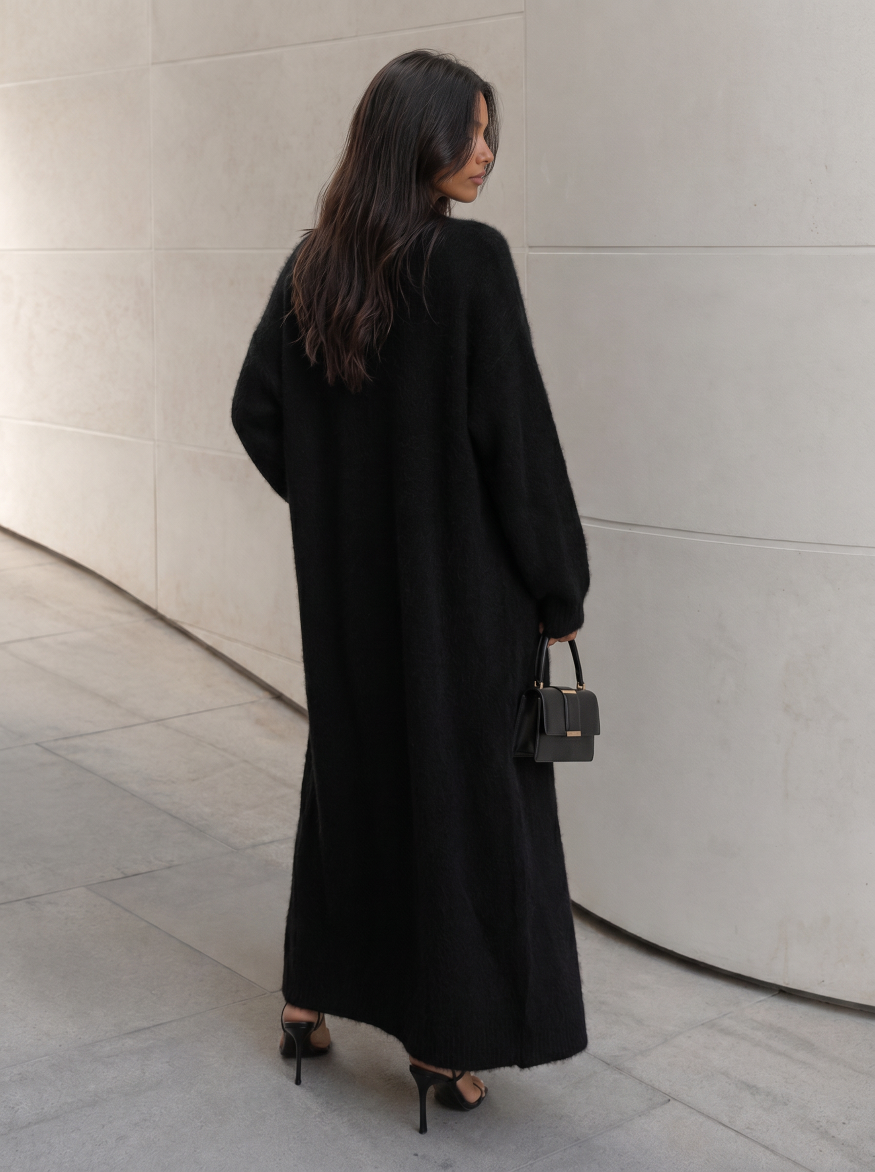 a long black cardigan with a high slit