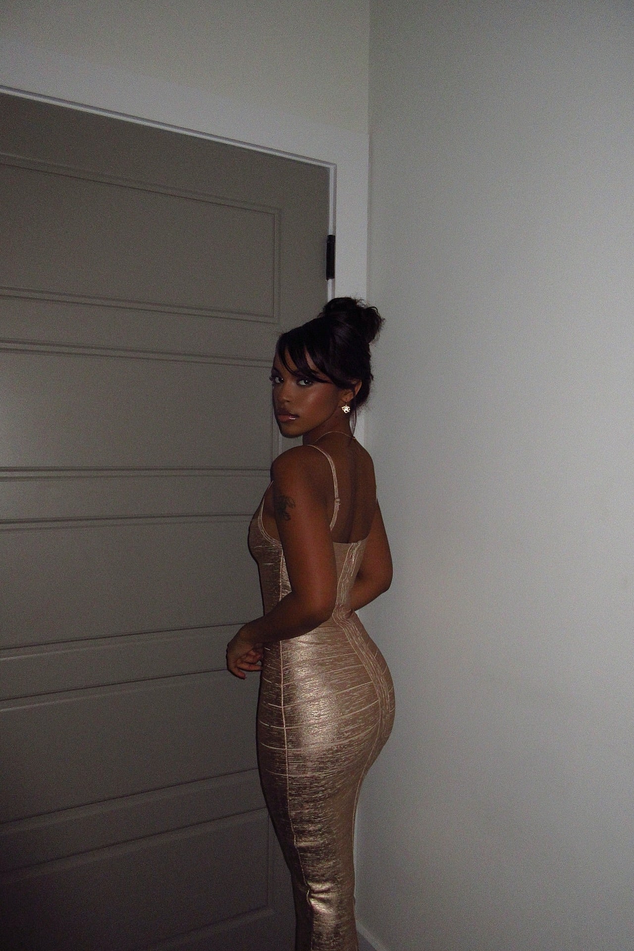 Gold metallic bandage maxi dress with shimmering finish, side profile