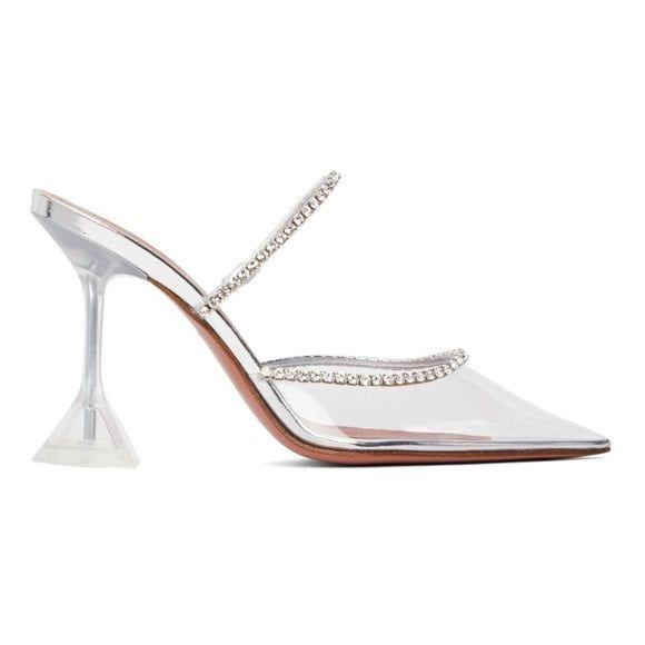 Clear high-heeled shoe with embellishments on a white background