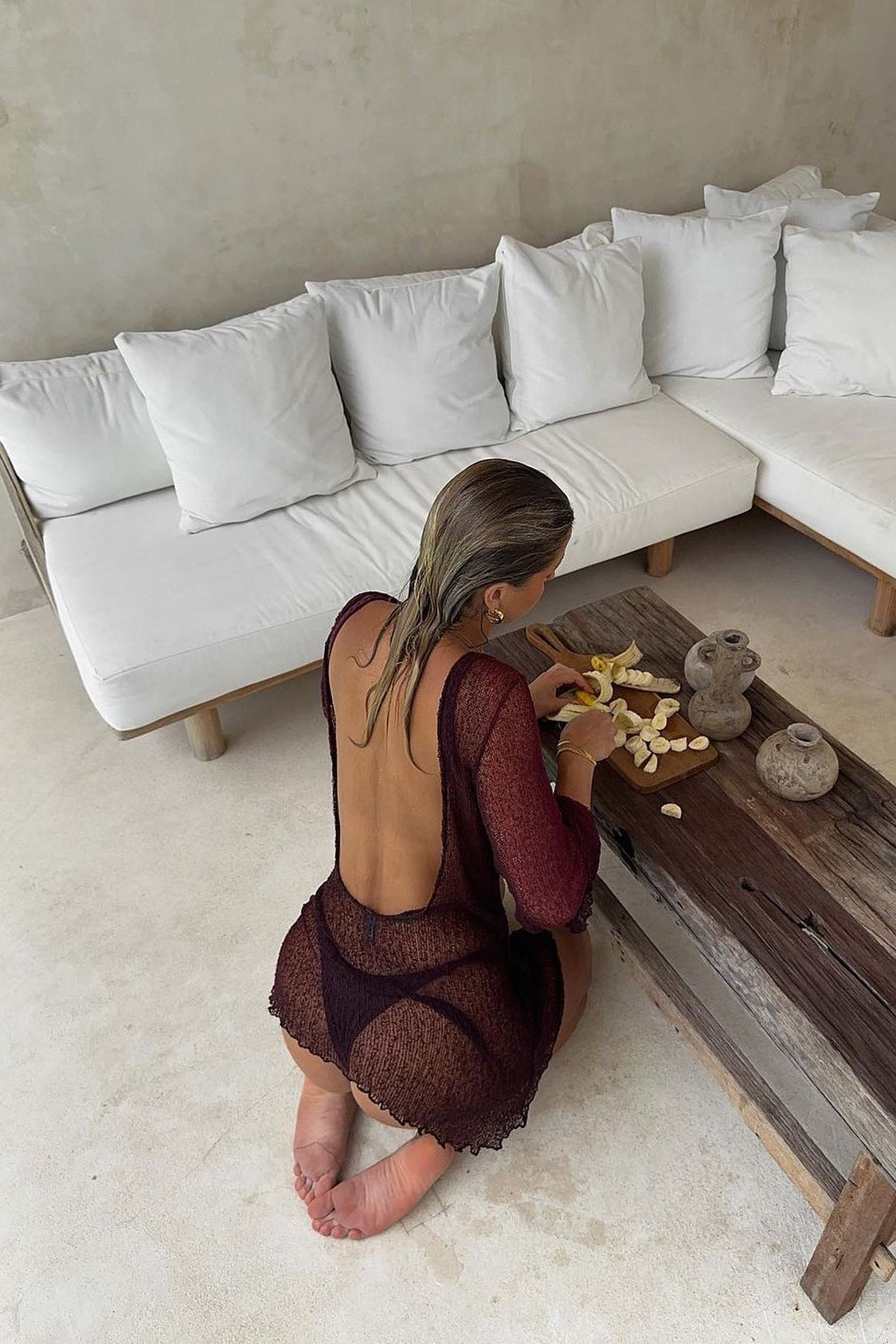 Semi-transparent burgundy beach mini dress with open back, golden-hour styling