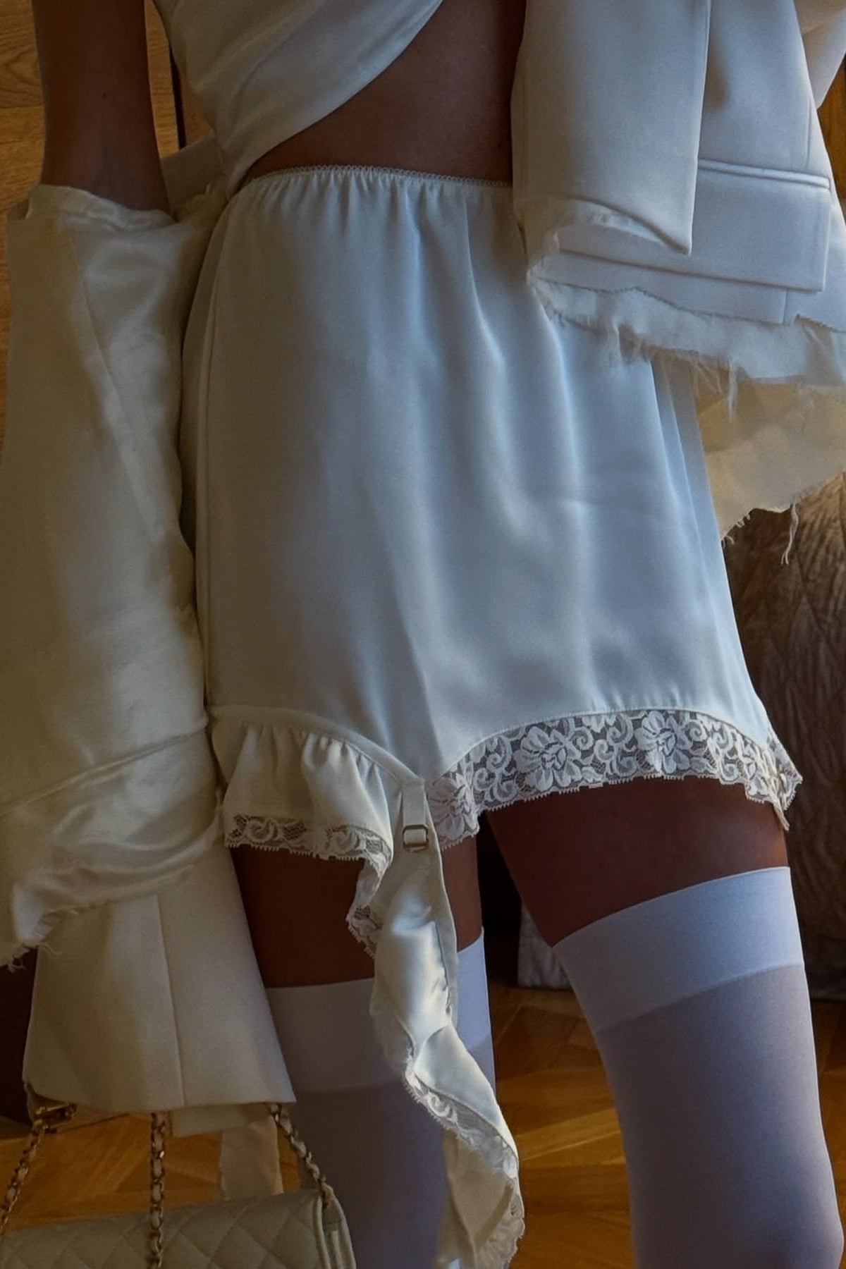 White asymmetric ruffle satin mini skirt, fashion editorial
