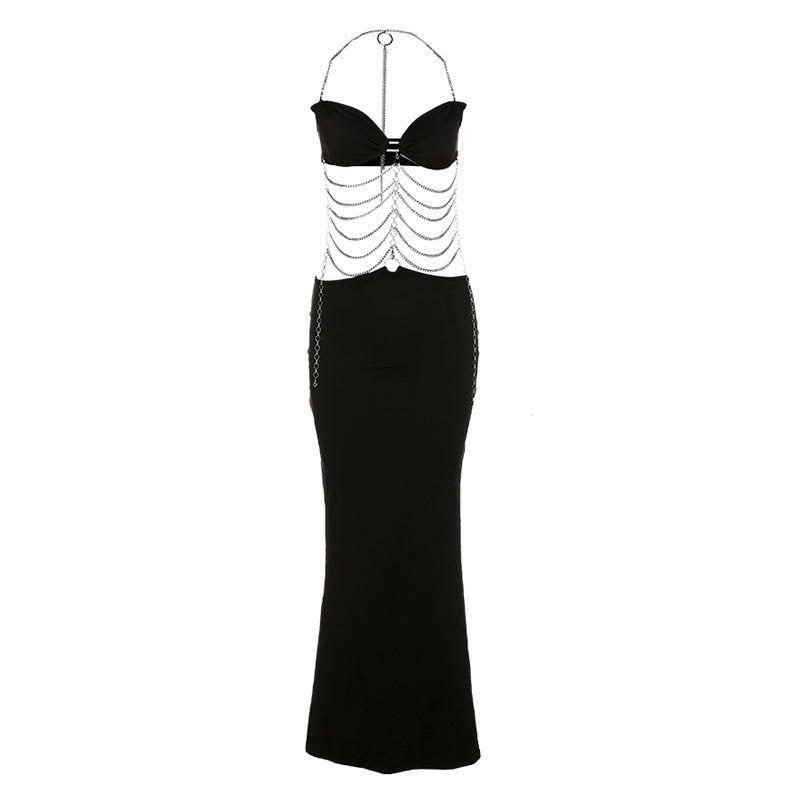 Black evening gown with white embellishments on a white background