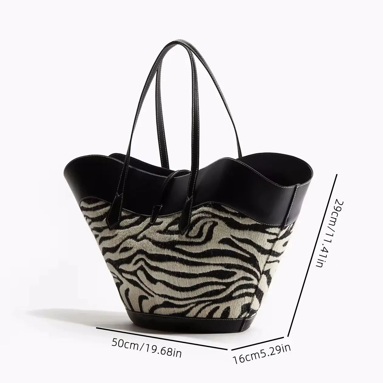 Zebra print tote bag with black leather accents.