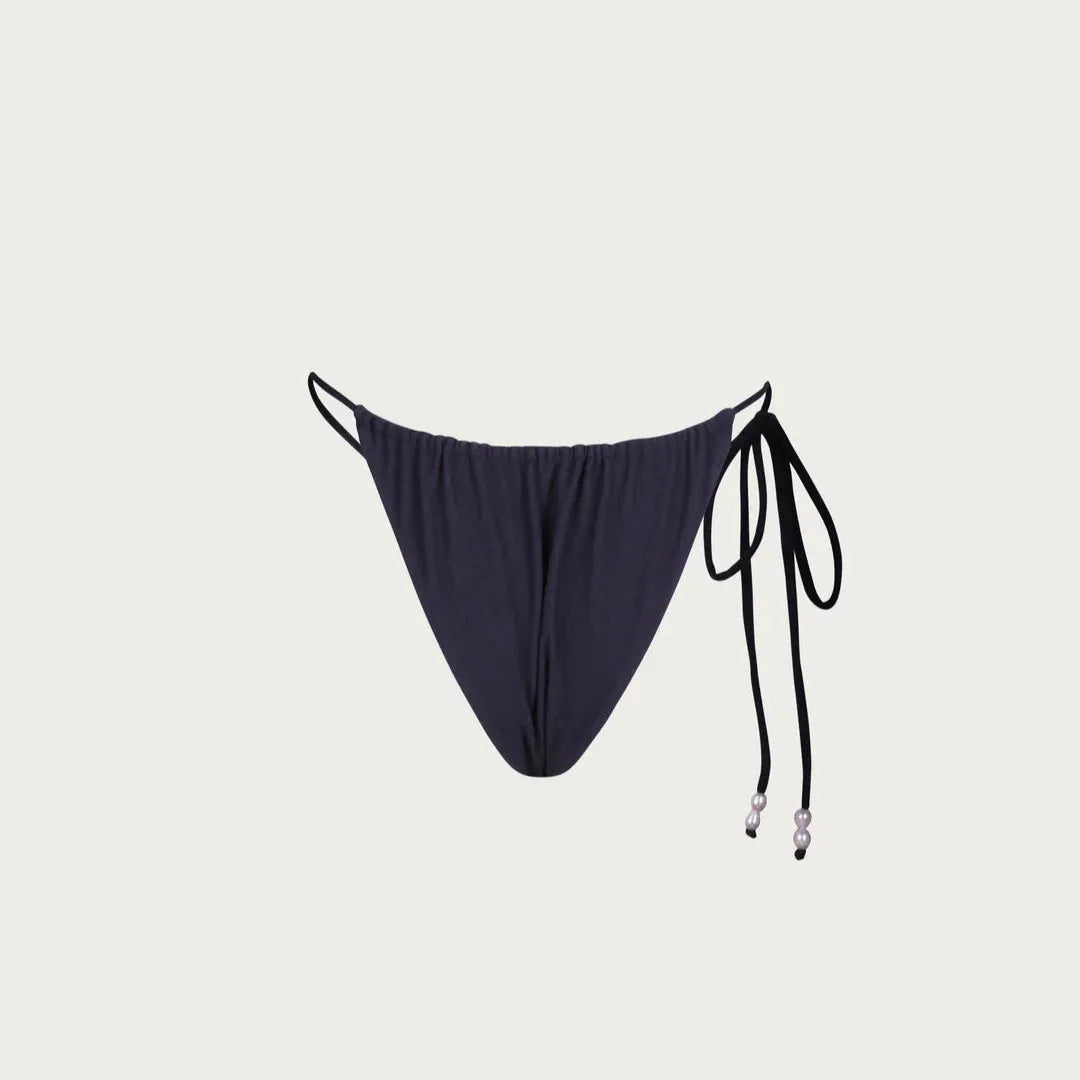 bikini bottom with thin straps on a light gray background