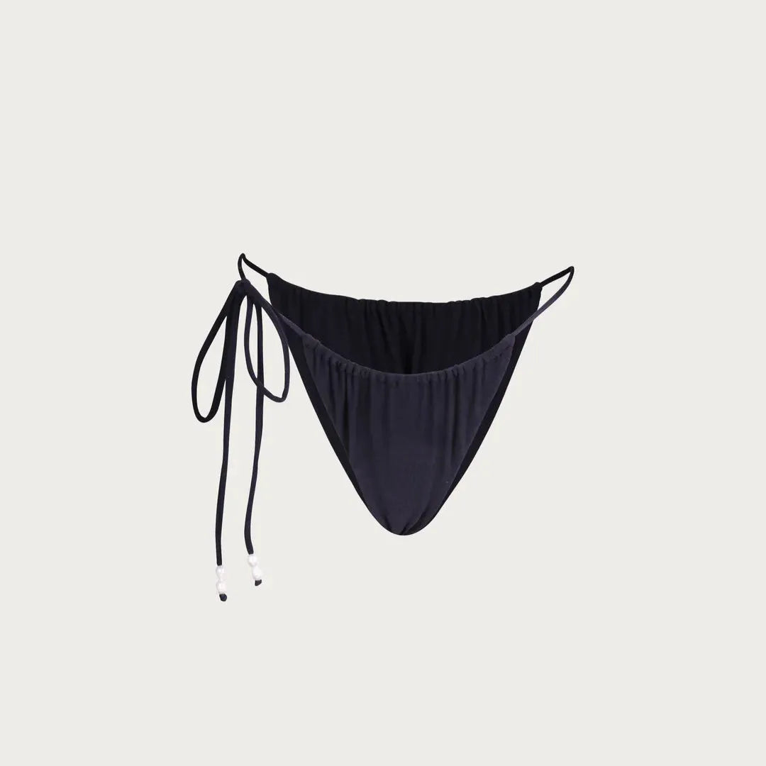 Black bikini bottom with tie sides on a light gray background