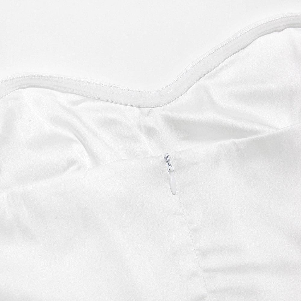 White satin garment with zipper closure, elegant evening wear.