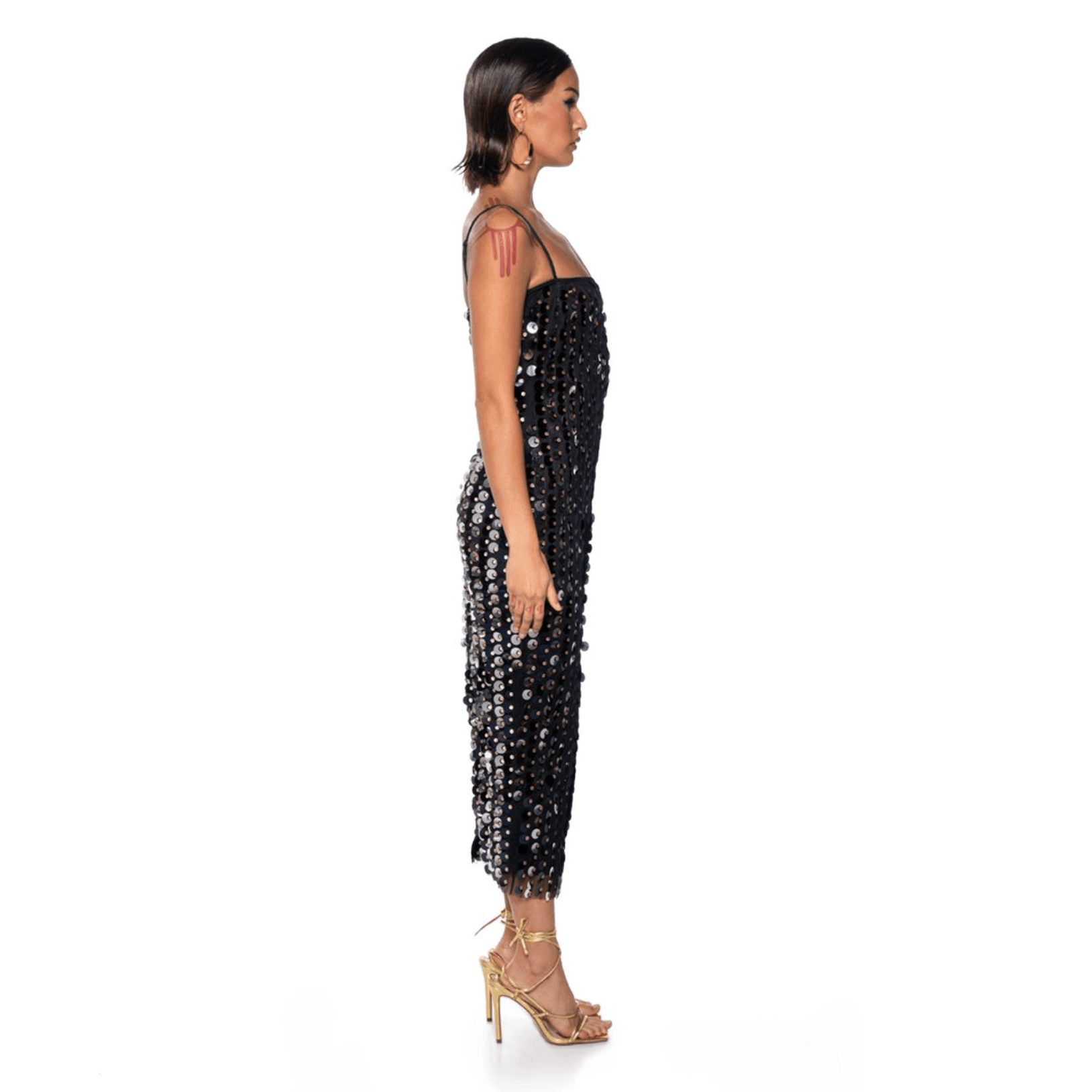 Black sequined midi dress with strapless design, fitted silhouette, styled with strappy heels for an elegant look.