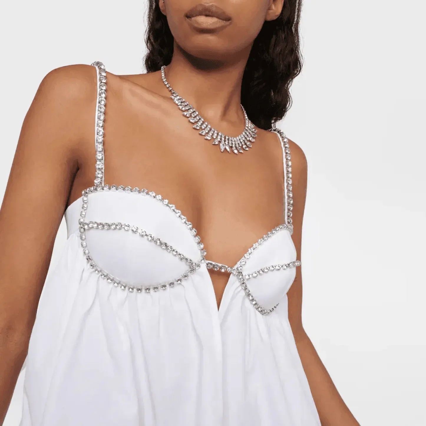 Rhinestone-embellished white dress with plunging neckline, elegant party wear