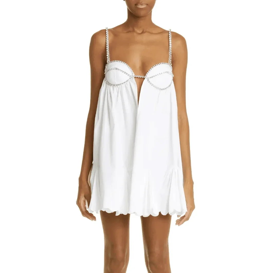 White mini dress with jeweled straps and scalloped hem, ideal for party styling