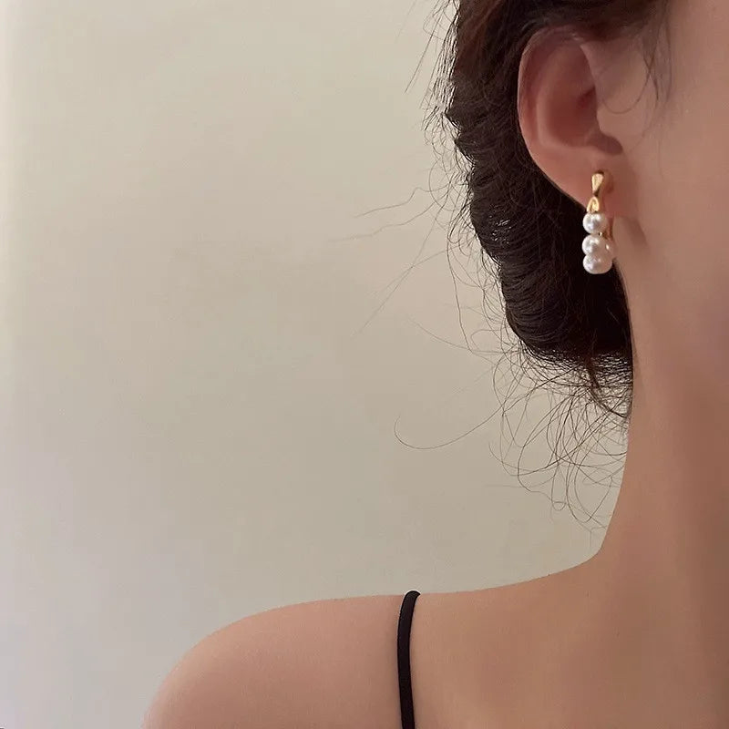 Gold hoop earrings with pearl accents, elegant accessory piece