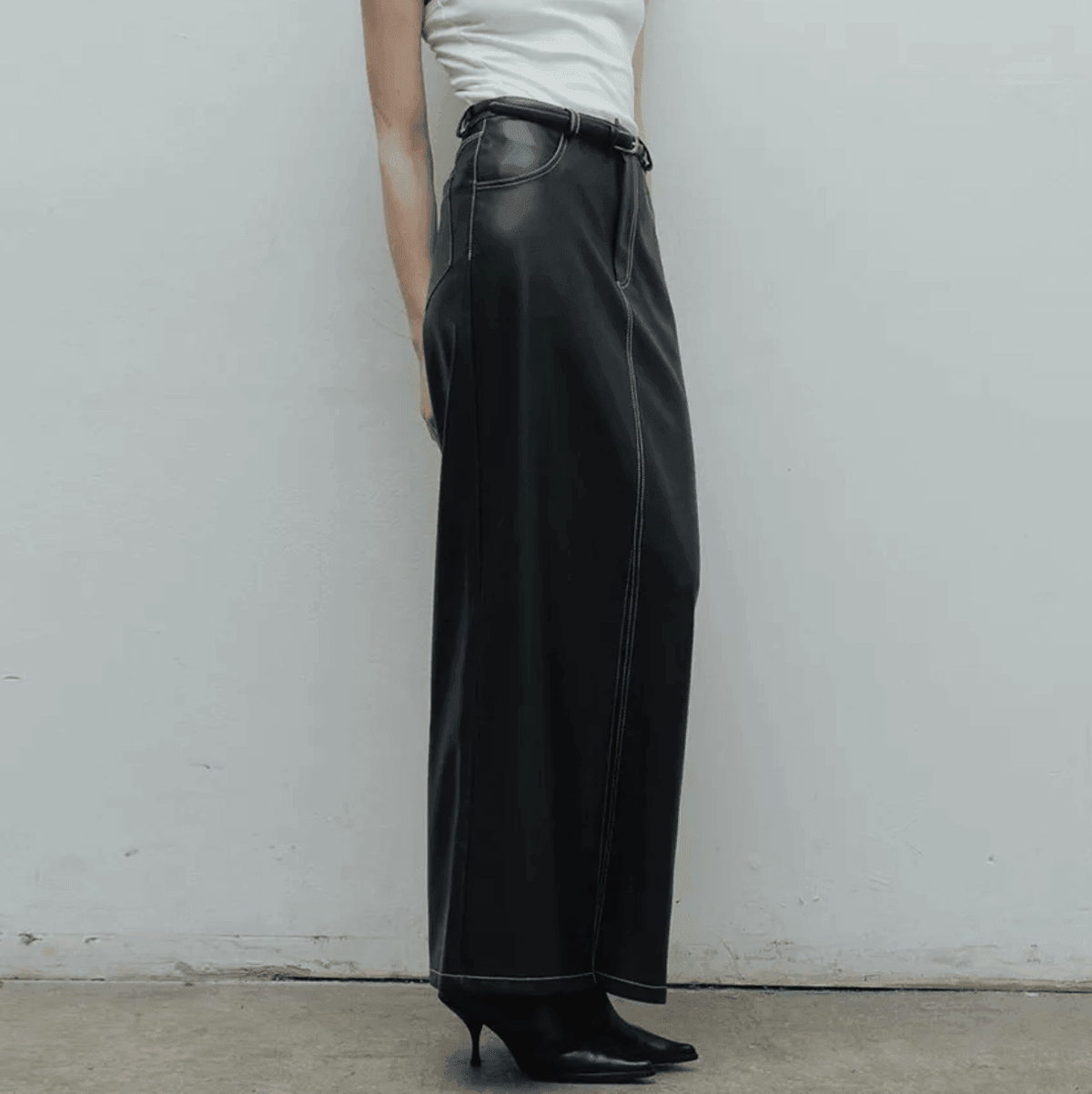 Wide-leg leather pants with white contrast stitching, sleek casual wear
