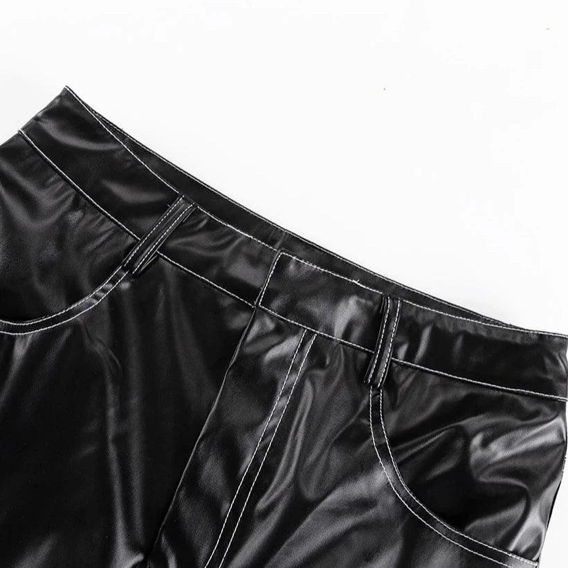 Black faux leather pants with white stitching.