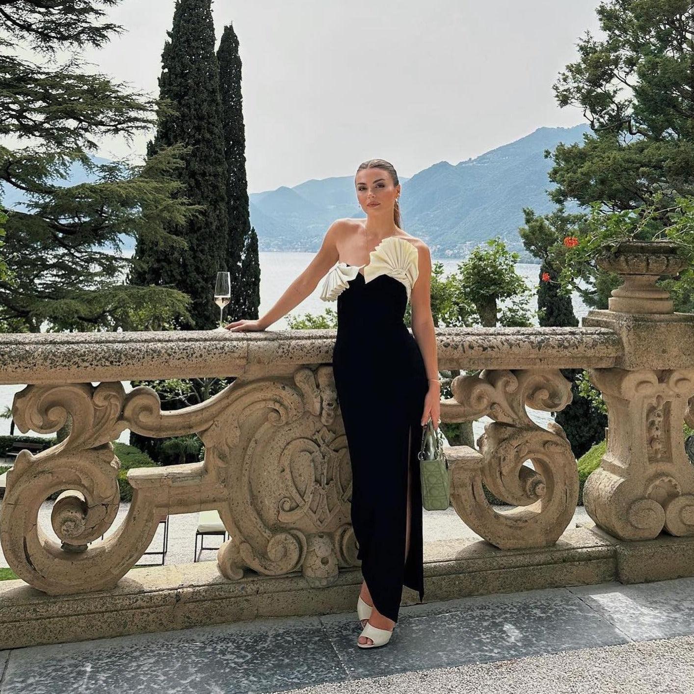 One-shoulder, ruffled black evening dress with side slit.