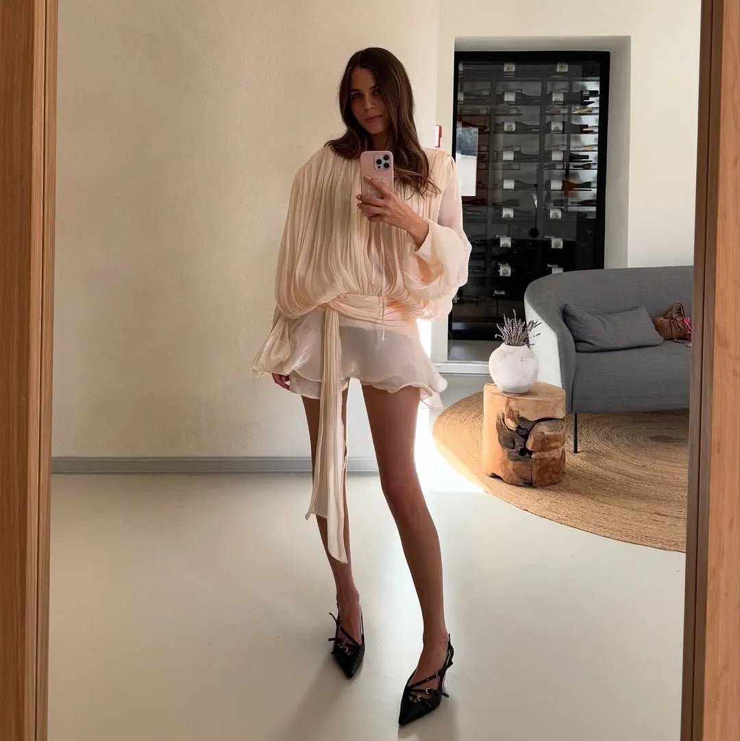 Flowy pleated blouse and ruffled mini skirt, elegant casual styling