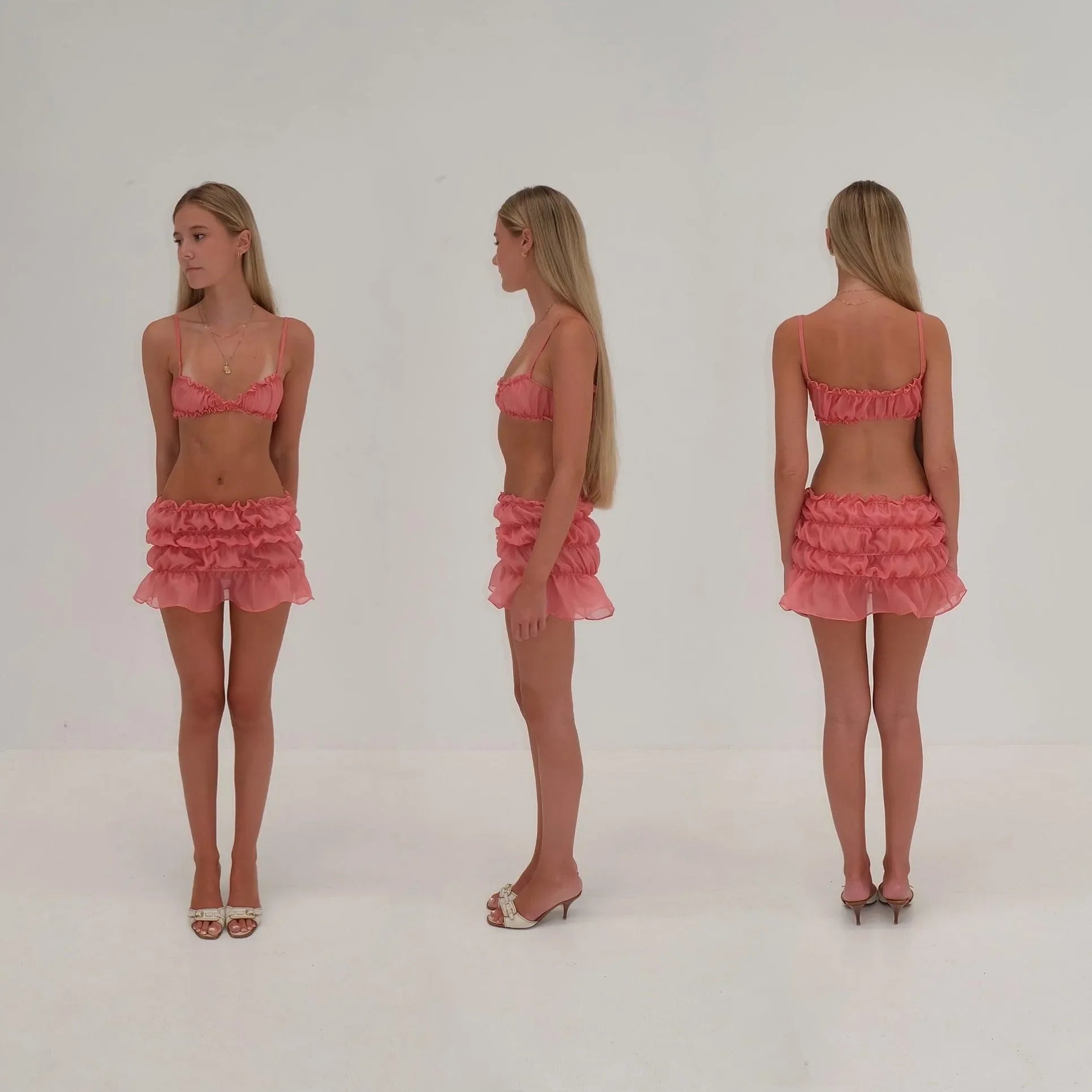 Pink ruffled co-ord set with bralette top and mini skirt, playful party outfit.