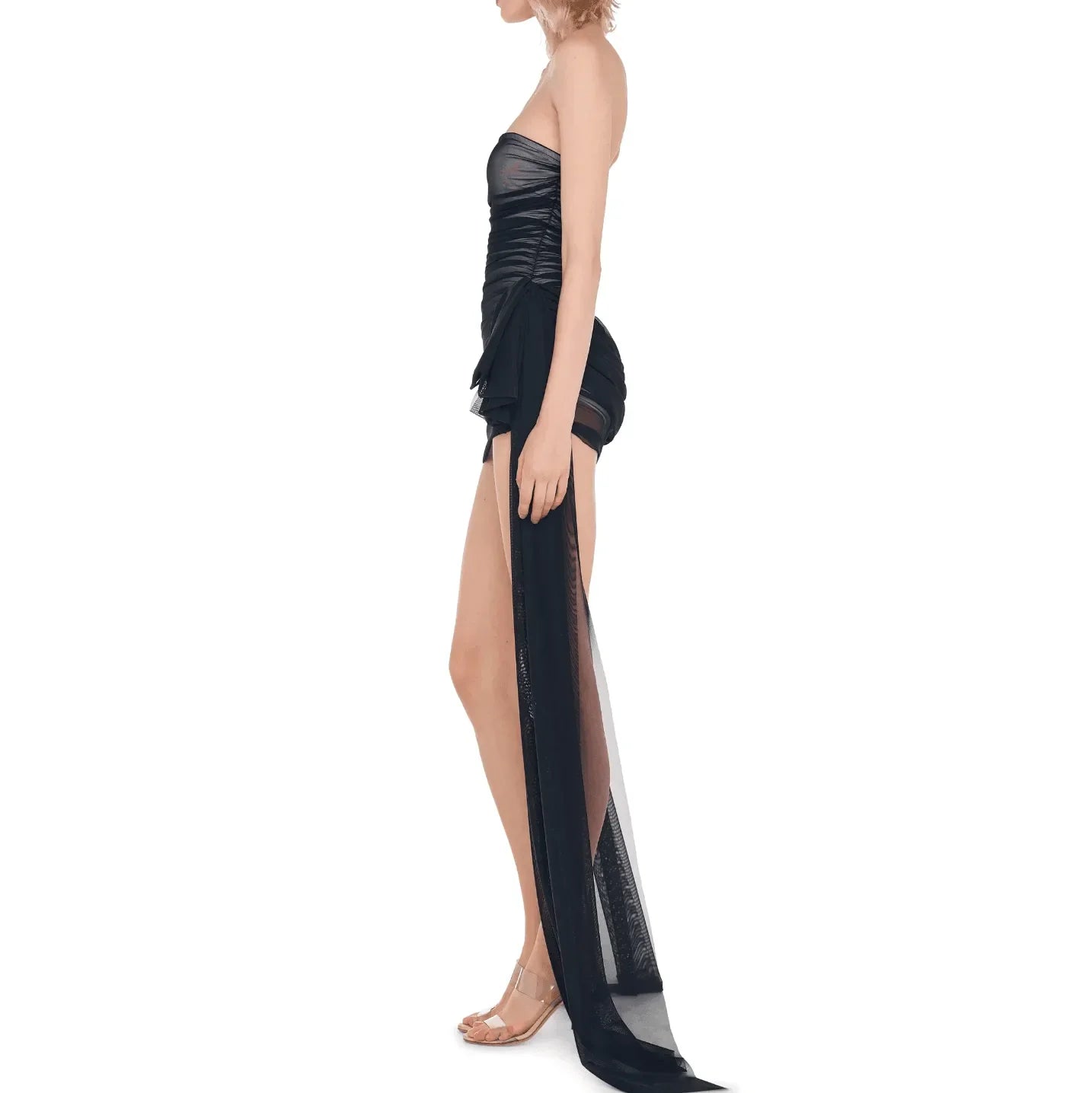 Black ruched mini dress with a sheer overlay, featuring a strapless design and a flowing back, styled for a chic look.