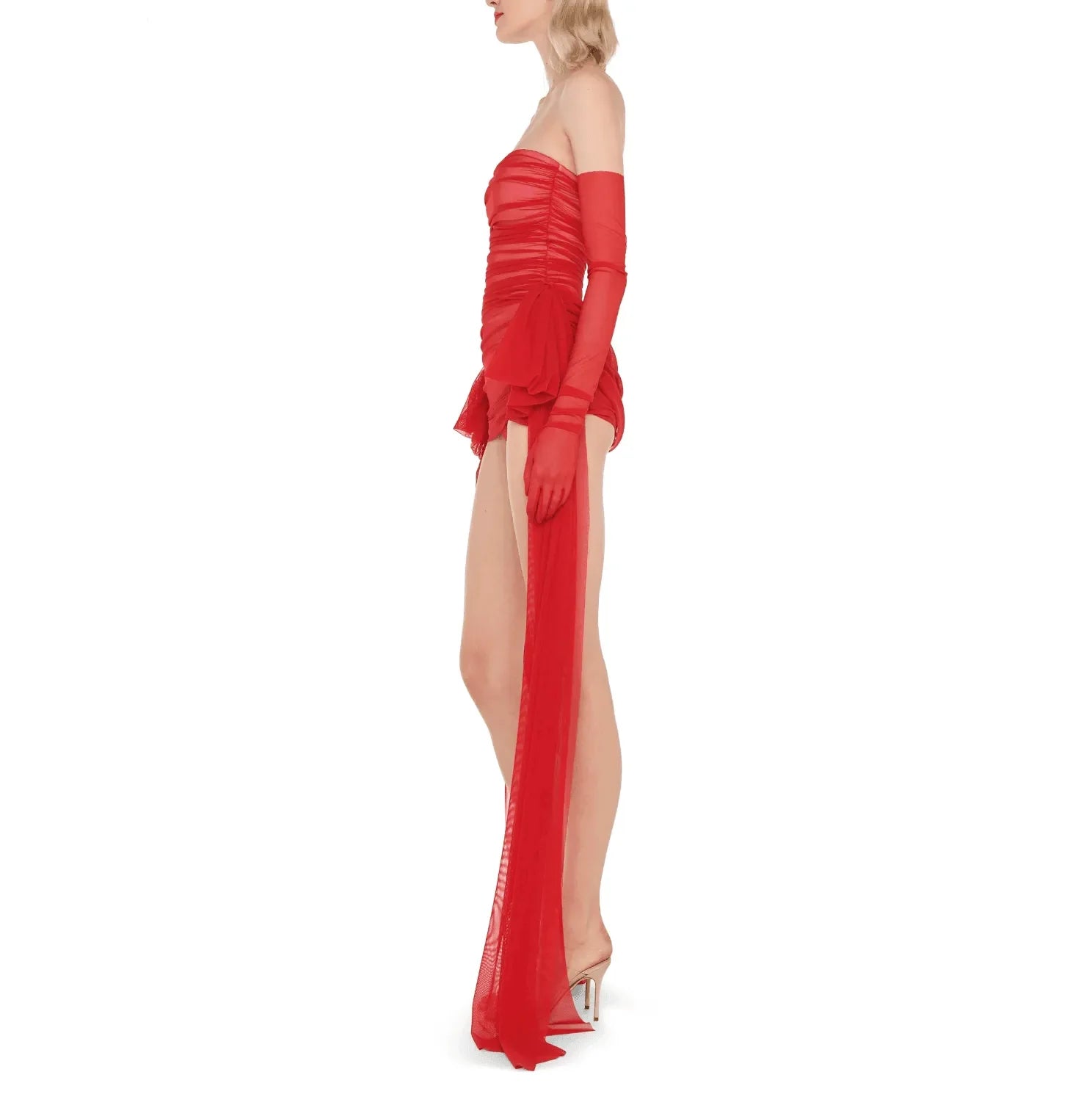 Red ruched mini dress with long mesh train and matching gloves, bold night-out look