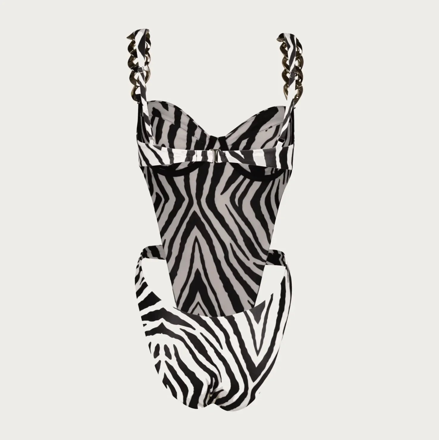 Zebra print one-piece swimsuit with chain details, featuring a fitted silhouette and adjustable straps for a chic look.