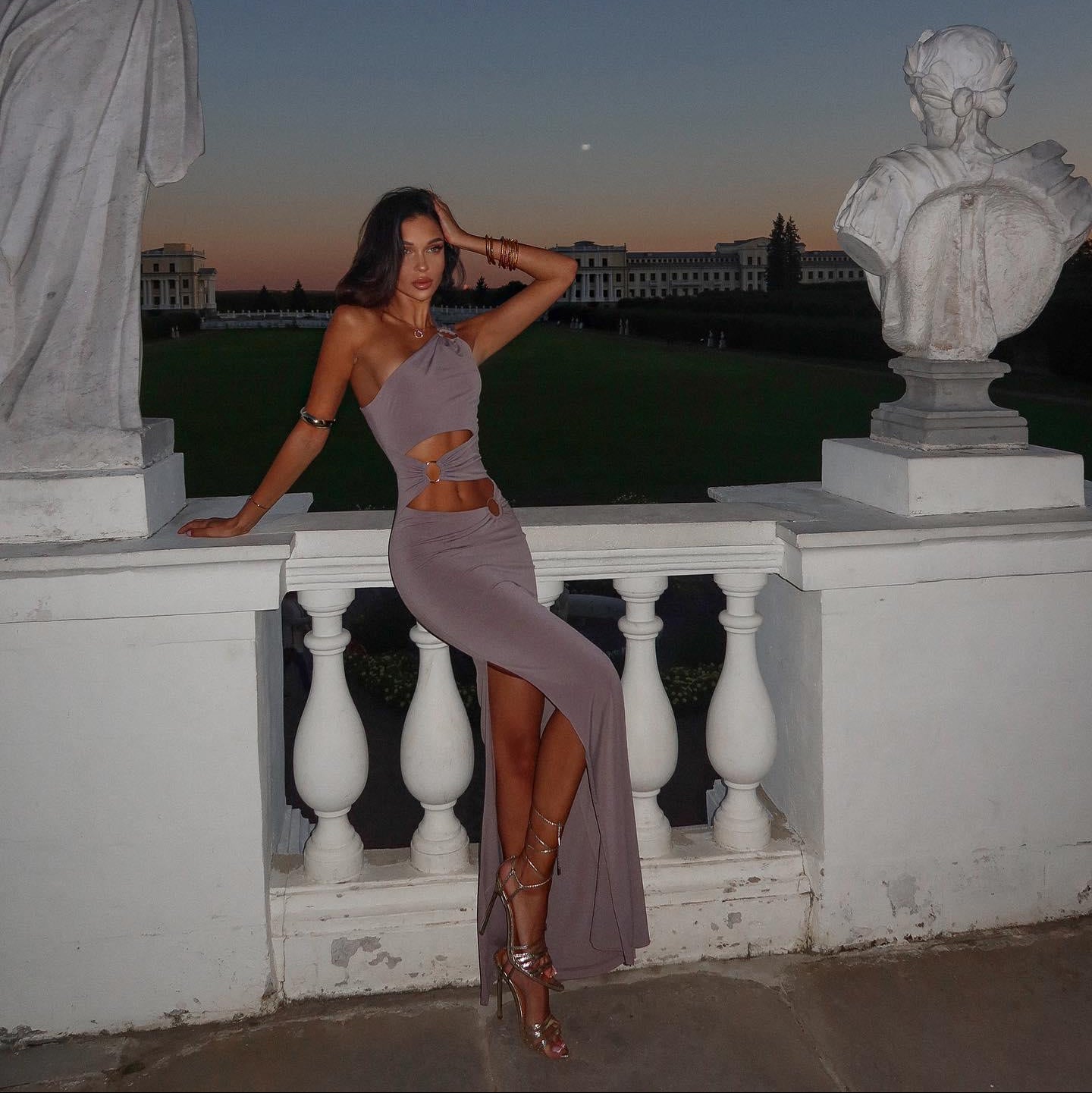One-shoulder cutout bodycon maxi dress with side slit, evening look.