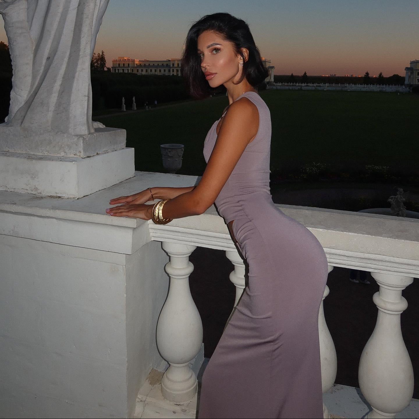 Form-fitting sleeveless maxi dress, elegant evening look.