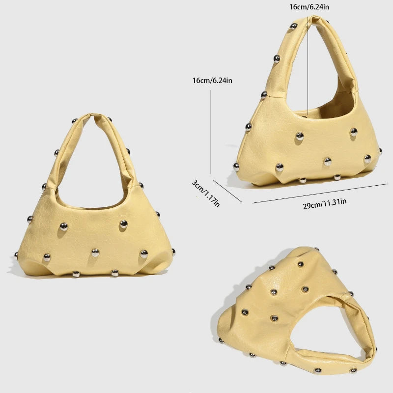 Yellow handbag with silver studs, stylish accessory for casual and party looks
