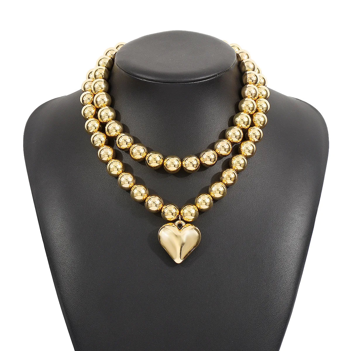 Gold-tone layered pearl necklace with heart pendant, statement accessory