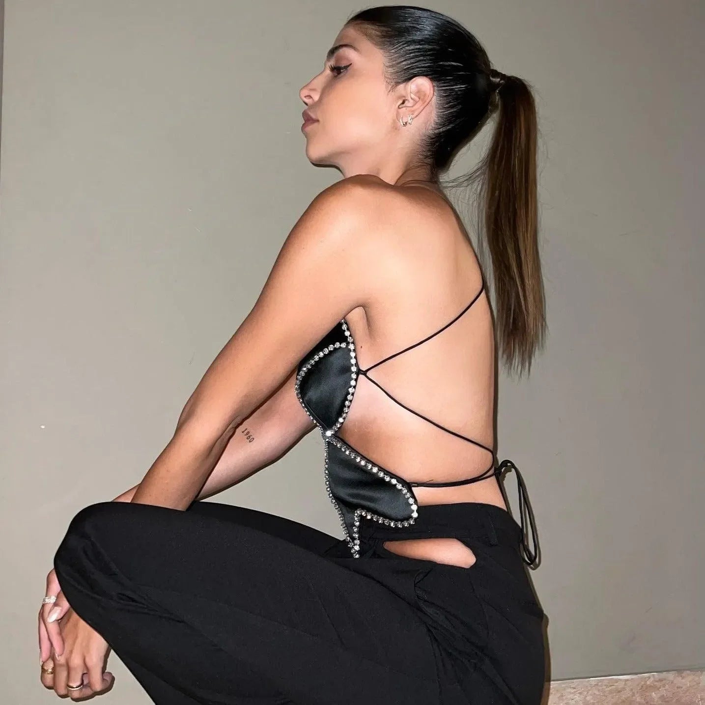 Backless satin top with crystal embellishments, evening night-out style.