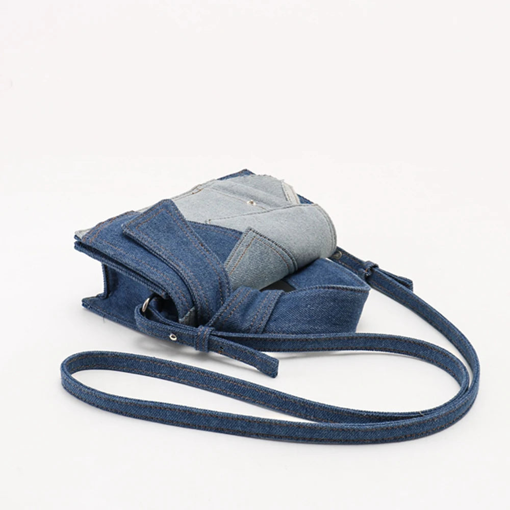 Denim crossbody bag with patchwork design, casual accessory.