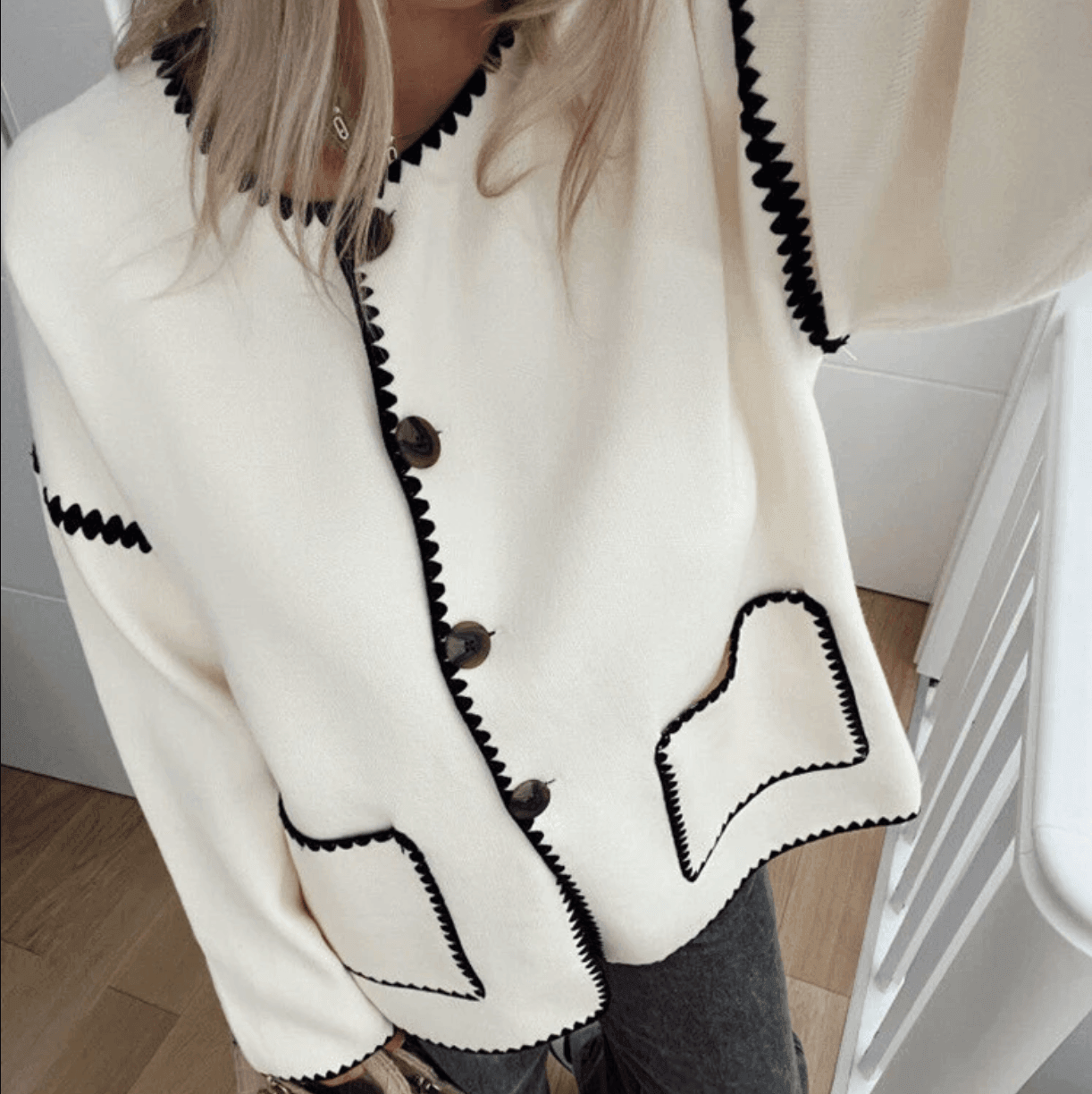 Cream cardigan with black trim and buttons, casual outerwear piece