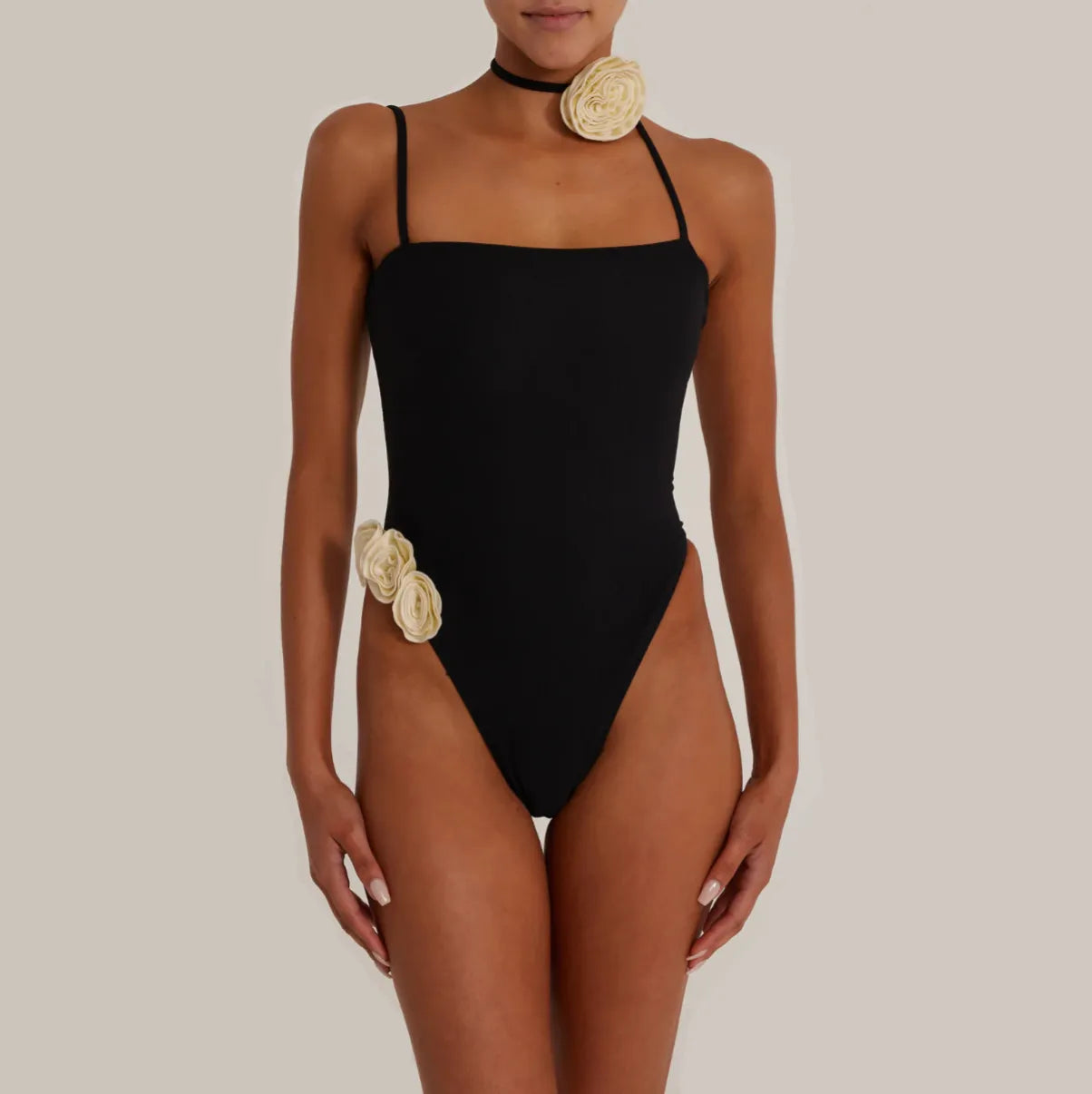 Black swimsuit with floral appliques, beachwear chic