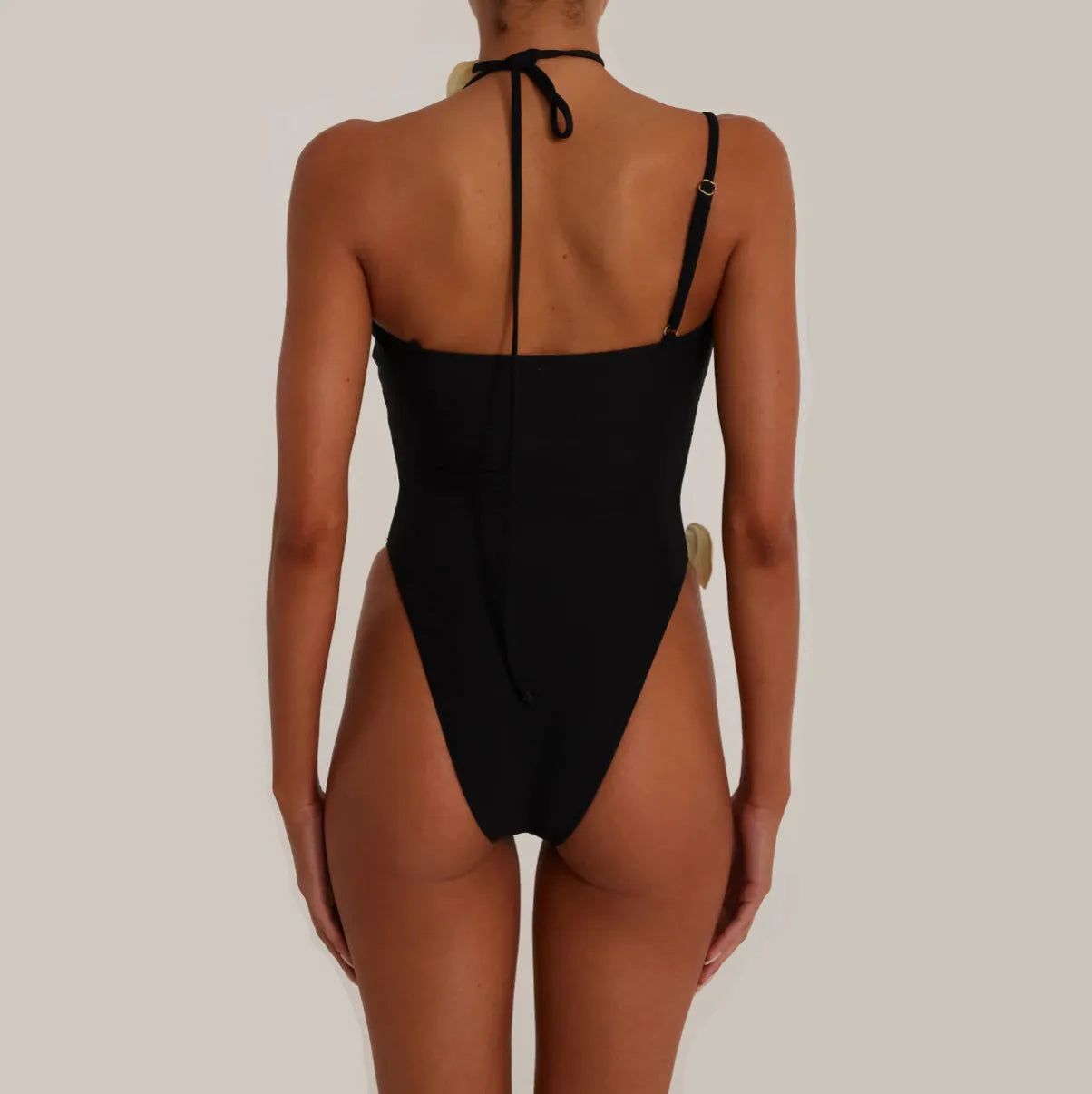 Black backless bodysuit with halter neck.