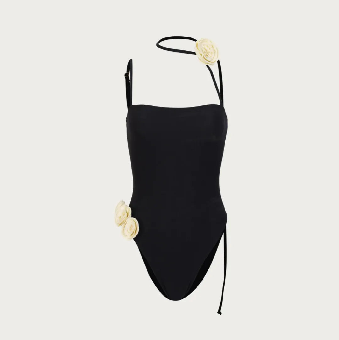 Black one-shoulder bodysuit with floral embellishments, evening look.