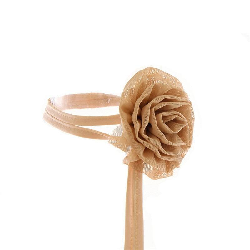 Beige mesh choker with large rose detail, statement accessory.