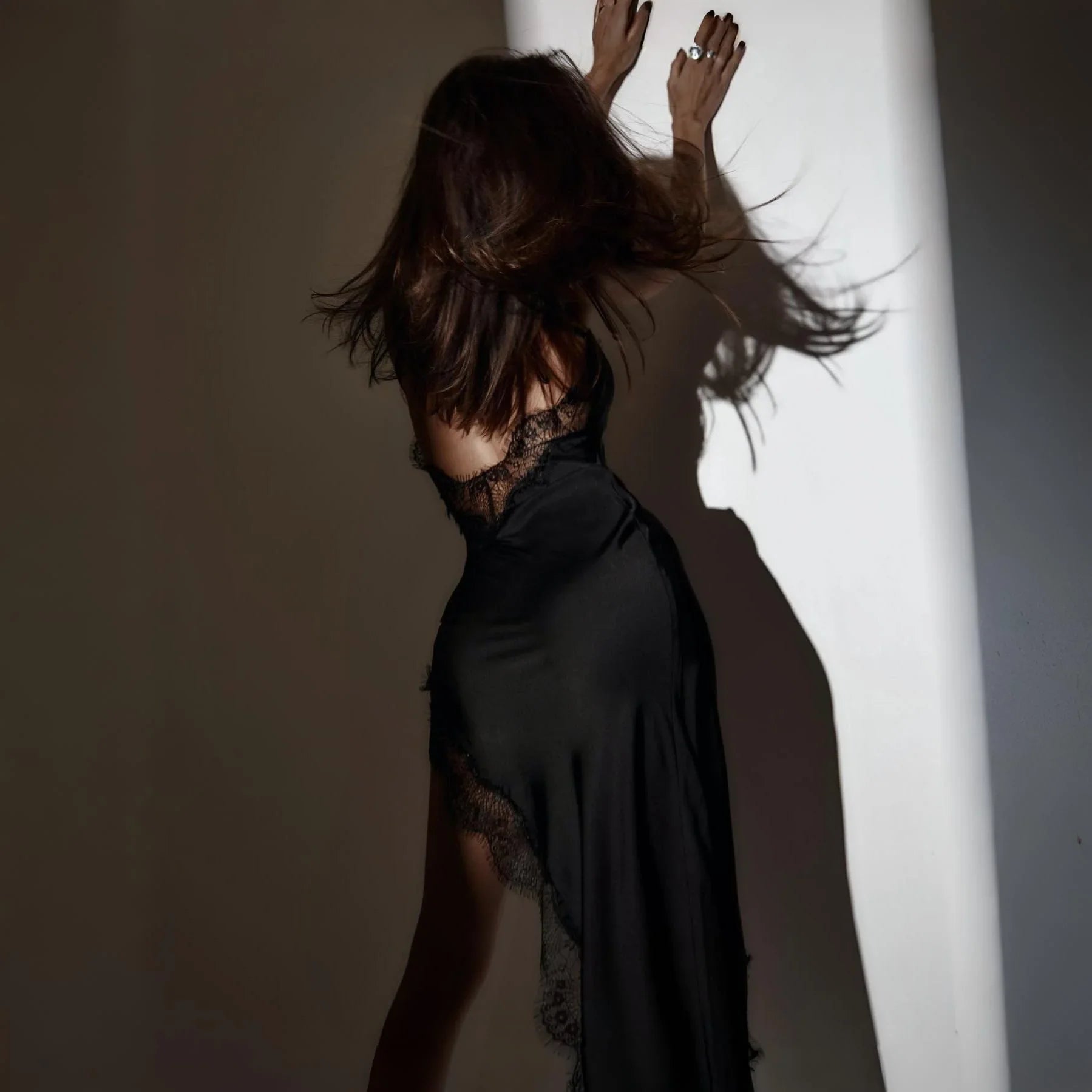 Black satin and lace backless evening dress.