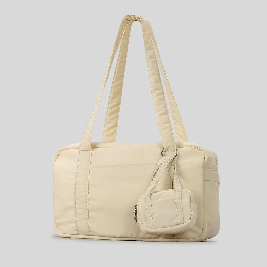 Quilted tote bag with detachable pouch, versatile accessory.