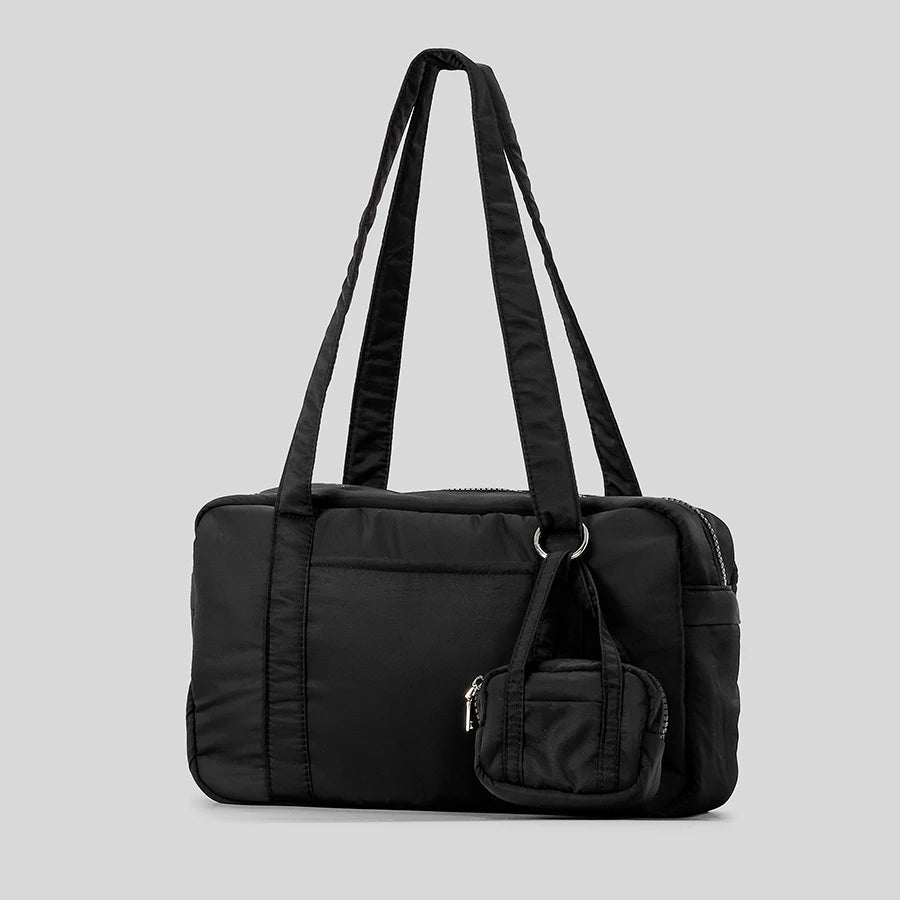 Black satin tote bag with detachable mini pouch, versatile accessory for day or evening use.