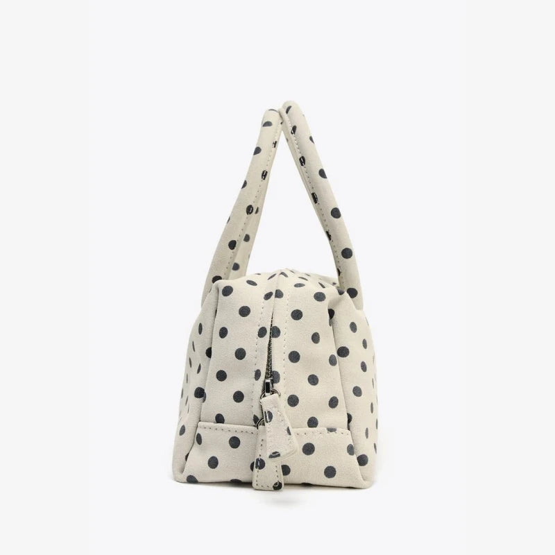 Polka dot fabric handbag with zipper detail, casual accessory piece