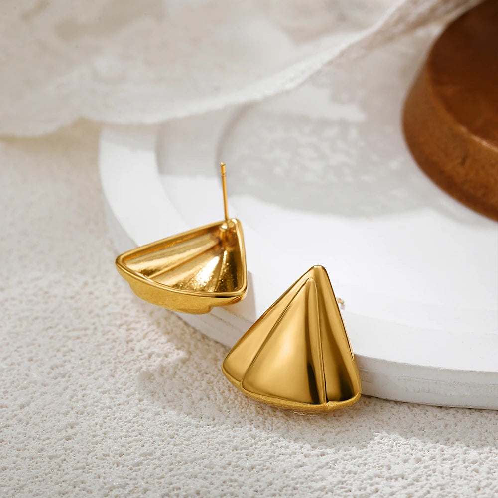 Gold geometric statement earrings for evening and party looks.